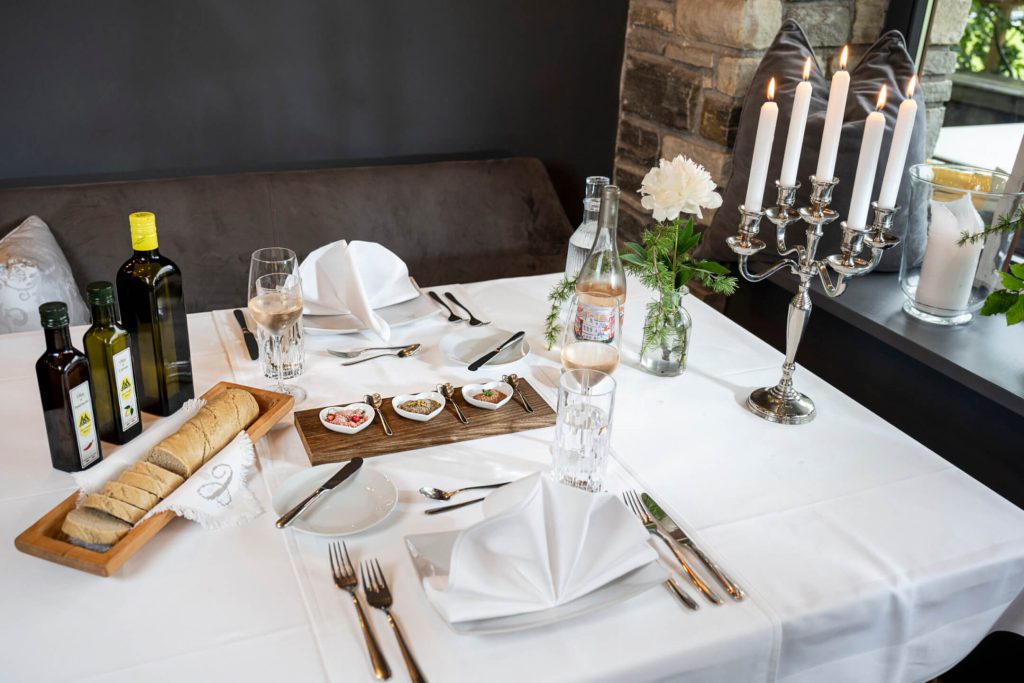Elegantly set table with regional delicacies and atmospheric candlelight at Hotel Lärchenhof.
