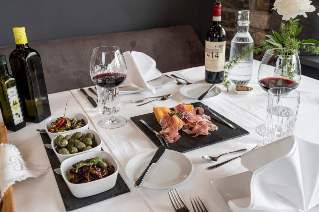 Exquisite food on the table at Hotel Lärchenhof with wine and regional delicacies.